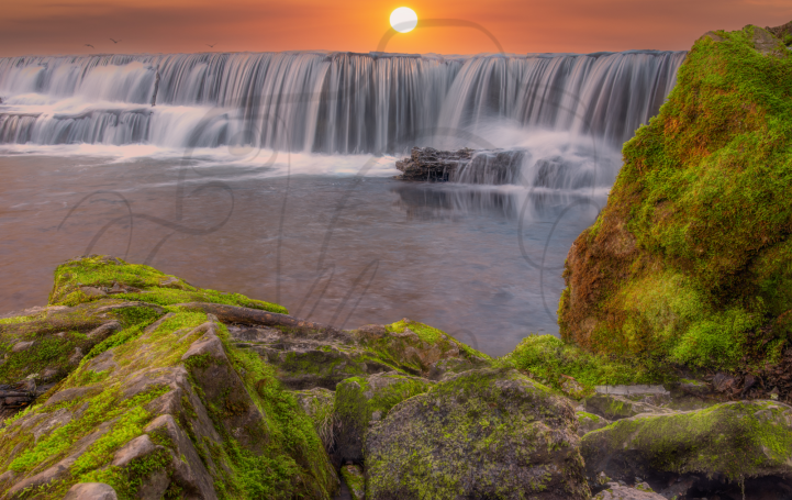 Mystical Waterfall With Mossy 
boulders